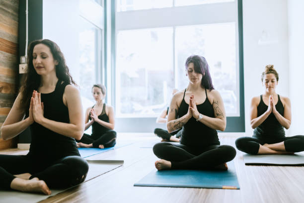 istock Women Exercising Together in Yoga Studio 958941998
