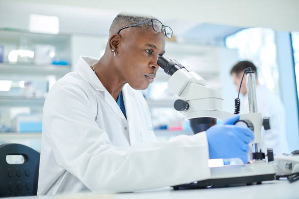 istock female scientist in a busy research lab 958943016