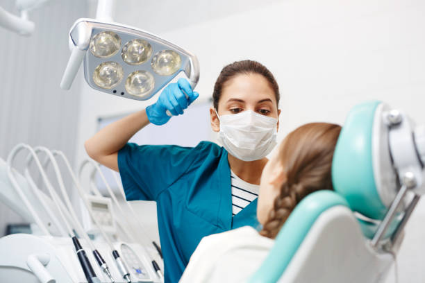 istock Concentrated dentist inspecting kids teeth 958946680
