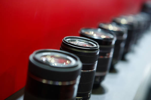 Close-up of the shiny camera lens. Very shallow depth of field. Focus on the lens surface. Note: High contrast proccessed which might add some noise to darker areas.
