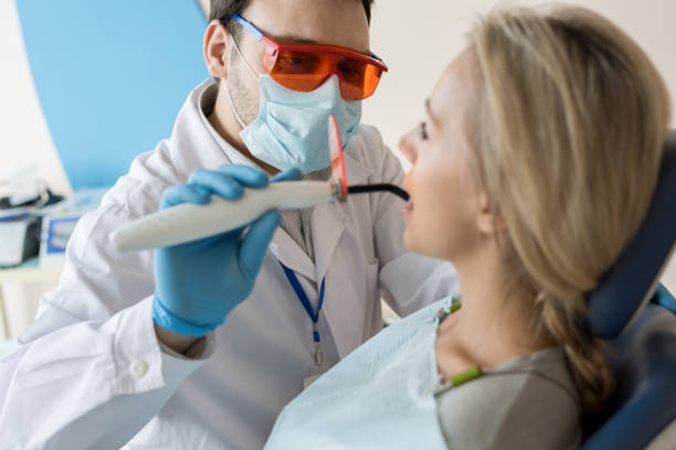 istock Dentist taking care of patient tooth 958950232