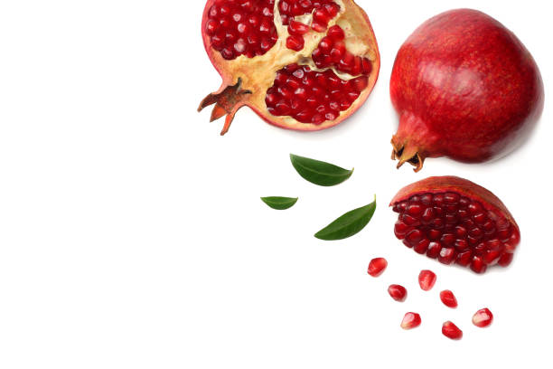 istock pomegranate fruit with green leaves isolated on a white background top view 958952804