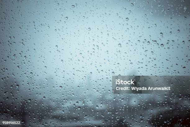 Rain Drops On Window Glass Outside Texture Background Water Of Wonderful Heavy Rainy Day With Sky Clouds At City Blue Green Blurred Lights Abstract View Sunshine Enjoy The Relaxing Nature Wallpaper Stock Photo - Download Image Now