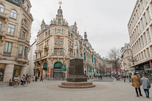 Antwerp, Belgium - April 2:  Square with monument to Sir Anthony van Dyck, flemish artist, and walking city people on April 2, 2018. More than 1,200,000 people lives in Antwerp