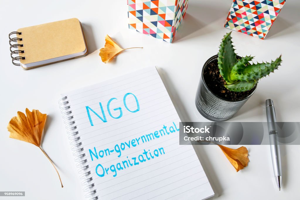 NGO Non-Governmental Organization written in notebook NGO Non-Governmental Organization written in notebook on white table Manager Stock Photo