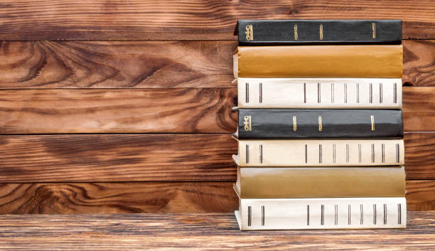 istock Stack of books on the wooden background. 958977444
