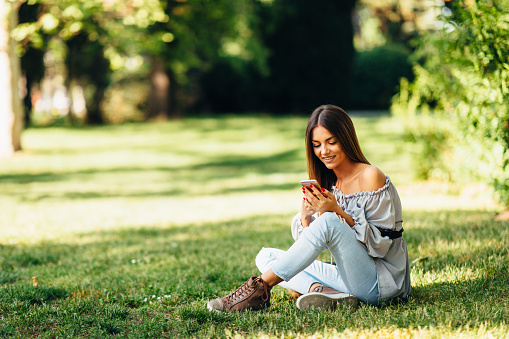 Young woman using a smartphone in the park