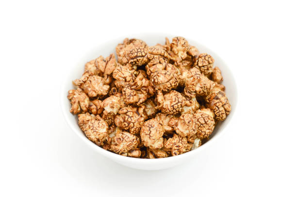 istock Closeup chocolate popcorn in white Bowl on white background. 958980936