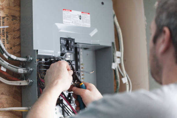 Electrician Upgrading a Homes Distribution Board stock photo