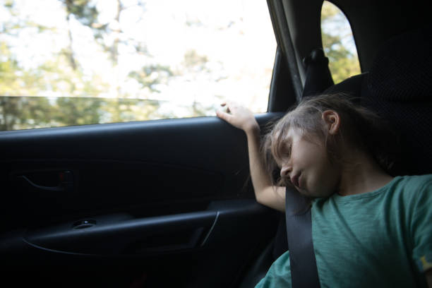istock Young Girl Falling Asleep While Traveling in Car 958983984
