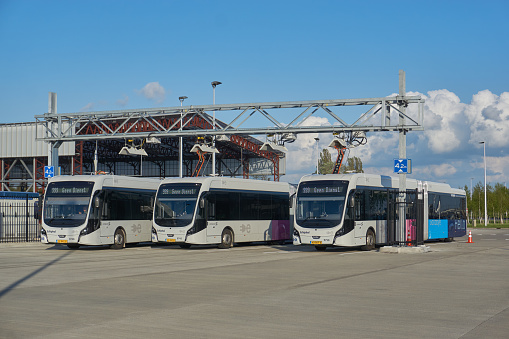 Lodz, Poland - 27th April, 2023: Electric bus Volvo 7900 Electric on a charging point on a bus loop. The electric buses replaces Diesel as fuel in public transport in future.