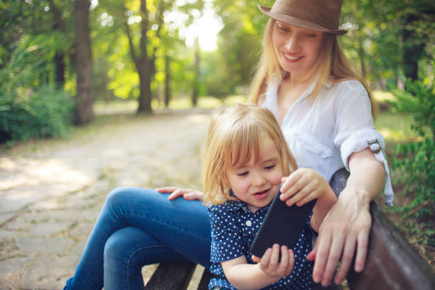 istock Mother and child making selfie in a park 958987592