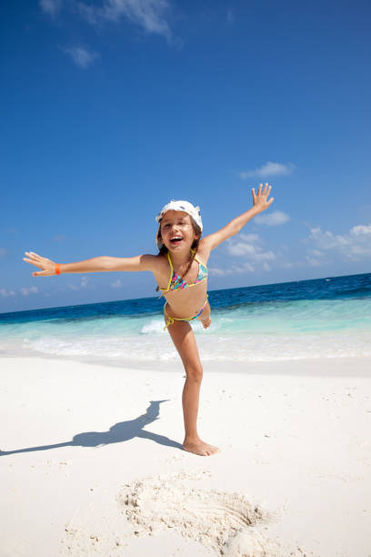 Happy Playful Girl Having Fun On Sandy Beach Stock Photo - Download Image  Now - Arms Outstretched, Beach, Beach Holiday - iStock