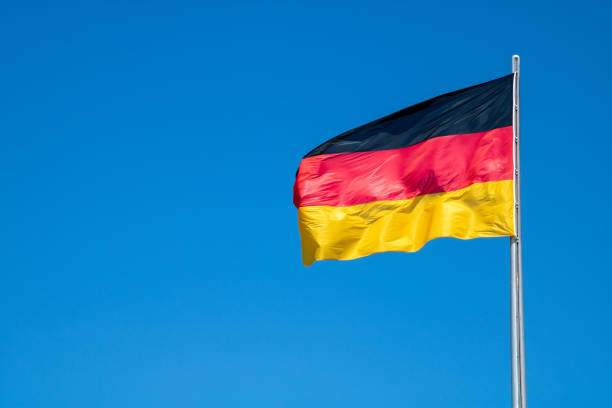 istock Official german flag in the wind and blue sky 958988678