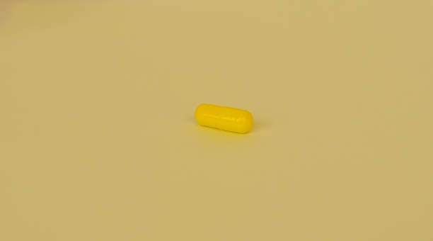 istock Yellow Tablet medicine pill capsule 958988940