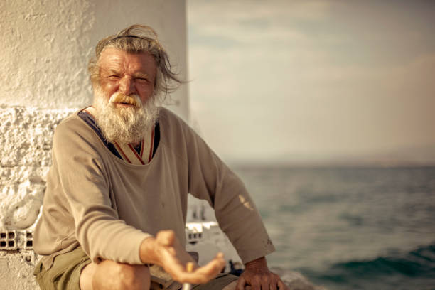 istock Old fisherman  by the sea 958989068