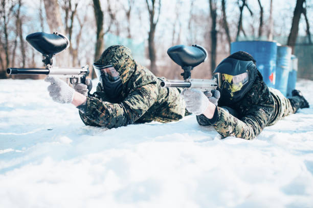 istock Two paintball players lies on the snow 958989936