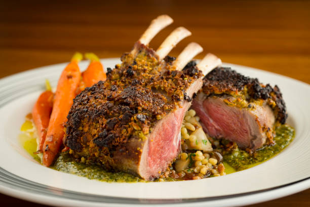 Rack of lamb with carrots Smalll rack of lamb with carrots and nice sauce, medium rare rack of lamb stock pictures, royalty-free photos & images