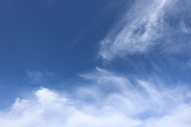 istock Close up of fluffy white clouds against blue sky 959000940