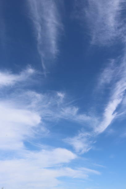 istock Close up of fluffy white clouds against blue sky 959001234