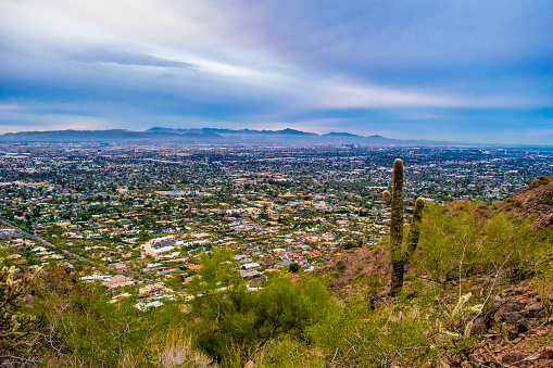 Wide view of valley, hills and city of Reno, Nevada from a lookout with a covered bench.
