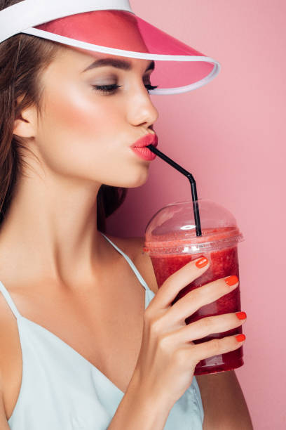 istock Beautiful girl drinks smoothies 959004006