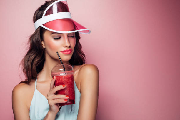 istock Beautiful girl drinks smoothies 959004026
