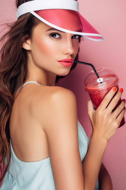 istock Beautiful girl drinks smoothies 959004054