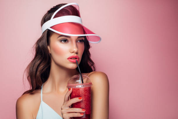 istock Beautiful girl drinks smoothies 959004092