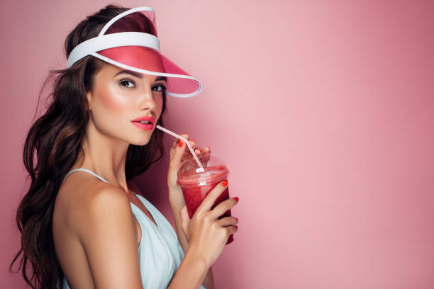 istock Beautiful girl drinks smoothies 959004198