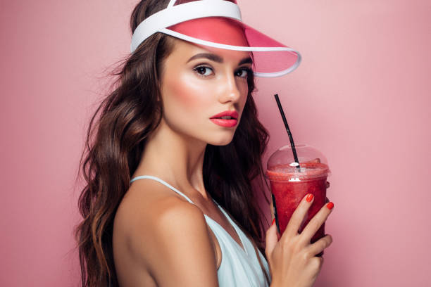 istock Beautiful girl drinks smoothies 959004212