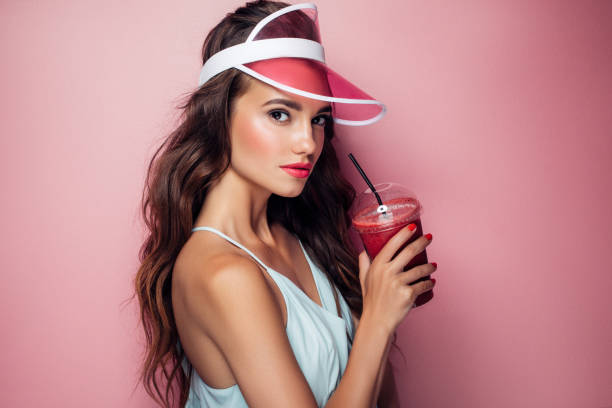 istock Beautiful girl drinks smoothies 959004236