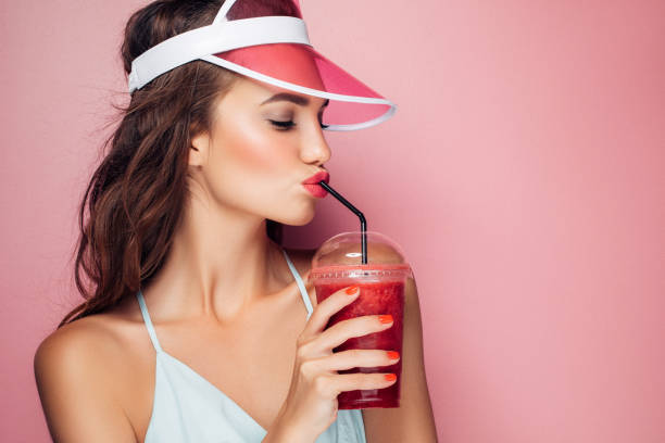 istock Beautiful girl drinks smoothies 959004320