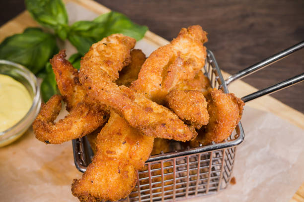 istock Nuggets on a wooden surface with sauce 959004768