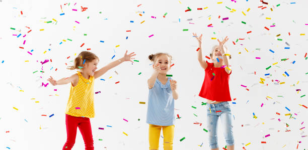 istock happy children on holidays  jumping in multicolored confetti on white 959011352