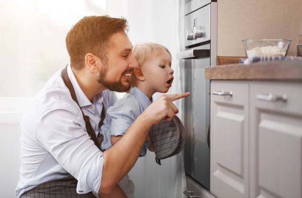 istock father with   child   son prepares meal, bakes cookies 959011668