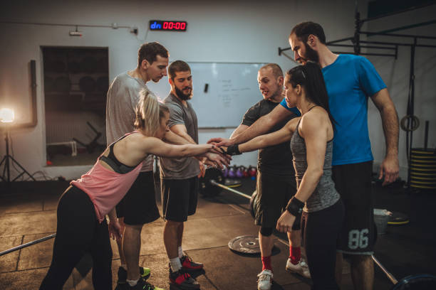 istock Friends in gym holding hands 959011734