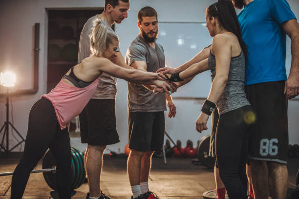 istock Friends holding hands in gym 959011848