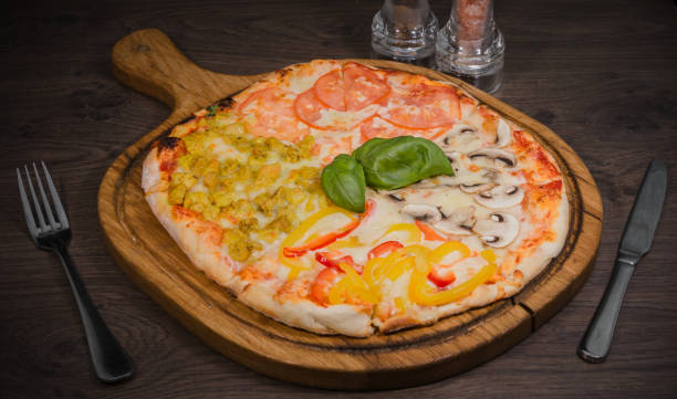istock Hot piece of pizza with melted cheese on a rustic wooden table 959012696