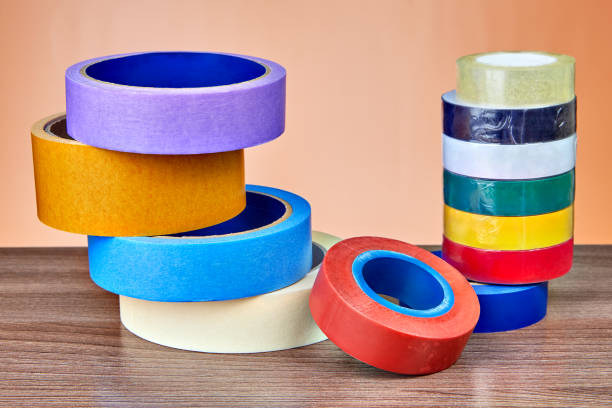 istock Two stacks of rolls of multi-colored adhesive tape. 959014900