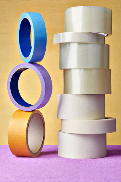 istock Many rolls BOPP and paper adhesive tape  on yellow background. 959014908