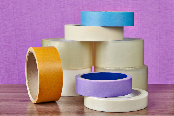 istock Coils of plastic and paper adhesive tape are on table. 959014930