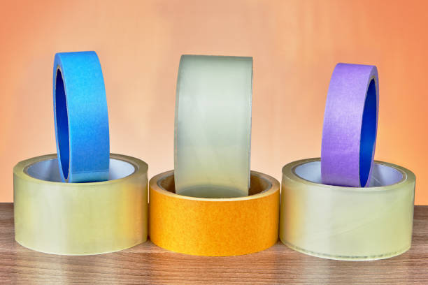 istock Various types of adhesive tape posted on an orange background. 959014932