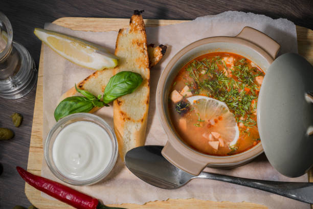istock Soup on a wooden background with white bread and sauce 959015882