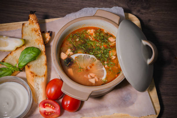 istock Soup on a wooden background with white bread and sauce 959015928