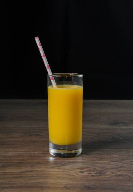 istock Fresh cold juice in a glass with a straw 959016844