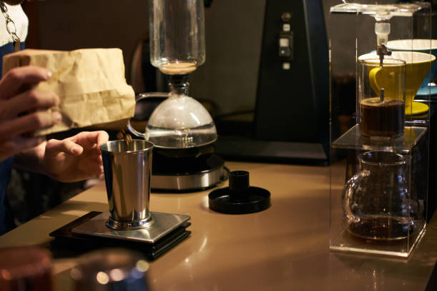 istock Barista weighs coffee on scales before preparing espresso 959020014