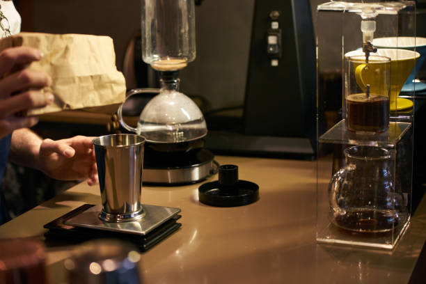 istock Barista weighs coffee on scales before preparing espresso 959020106