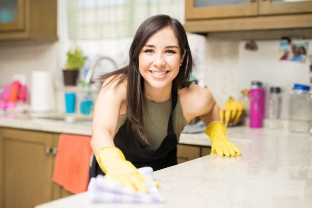istock Cheerful woman rubbing napkin in kitchen 959020622