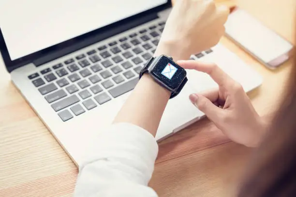 Photo of Business woman using smart watch show icon social email, Concept of communication and working online.